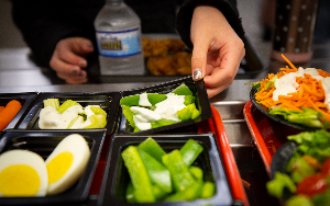  Student picks up vegetables for lunch